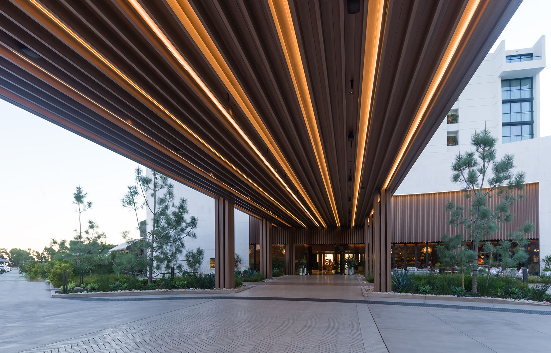 Ribbons of Light, The Exterior Porte Cochere wave inspired millwork draws your eyes from the circular waterfall to the lobby
